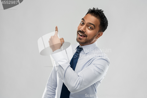 Image of indian businessman pointing finger at something