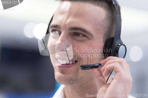 Image of male call centre operator doing his job