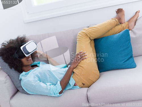 Image of black woman using VR headset glasses of virtual reality