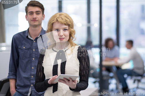 Image of Business People Working With Tablet in startup office