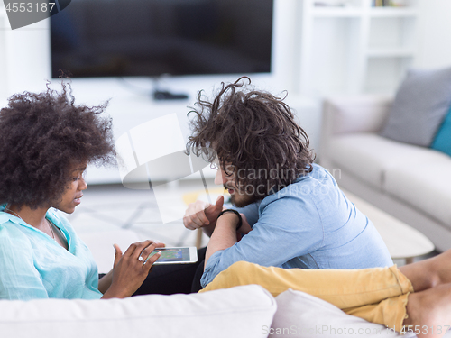 Image of multiethnic couple in living room