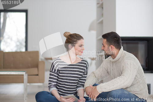 Image of Young Couple using digital tablet on cold winter day