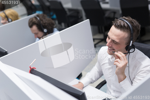 Image of male call centre operator doing his job