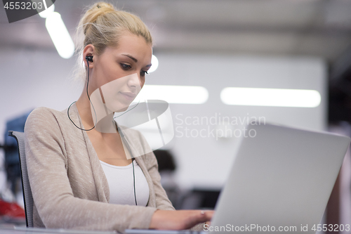 Image of businesswoman using a laptop in startup office