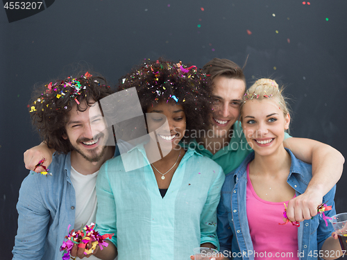 Image of confetti party multiethnic group of people isolated over gray