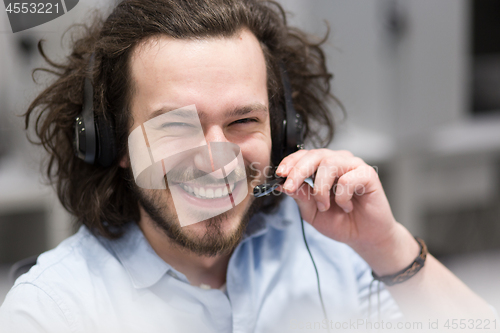 Image of male call centre operator doing his job