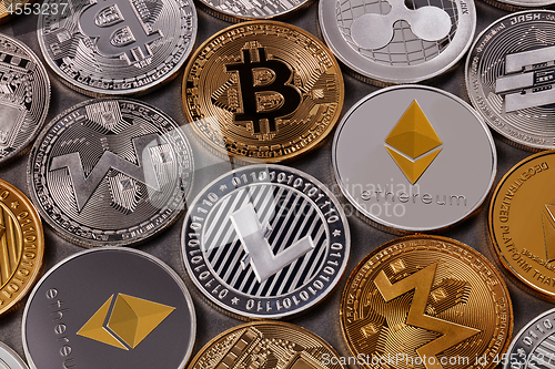 Image of Many different coins of crypto currency on a dark background. Business and technology concept. Top view