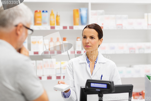 Image of apothecary showing drug to senior man at pharmacy