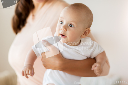 Image of close up of mother with little baby boy at home