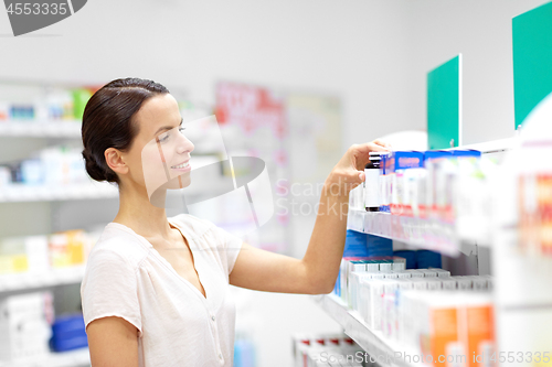 Image of female customer choosing drugs at pharmacy