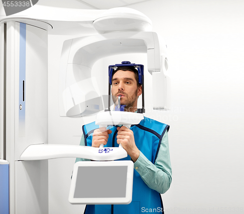 Image of patient having x-ray scanning at dental clinic