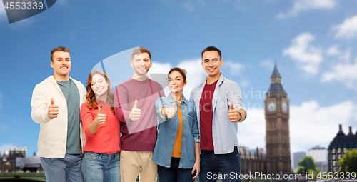 Image of group of friends showing thumbs up over london