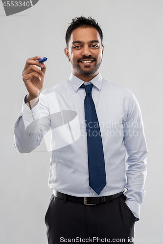 Image of indian businessman with marker over grey