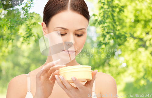 Image of beautiful woman with moisturizing cream