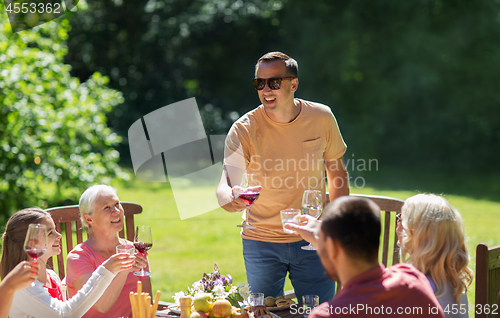 Image of happy family having dinner or summer garden party