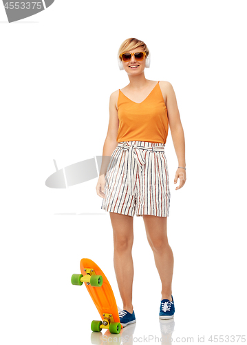 Image of smiling teenage girl with skateboard over white