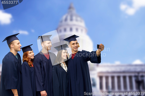 Image of graduates taking selfie by smartphone