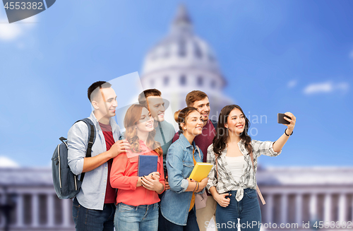 Image of students taking selfie over capitol building