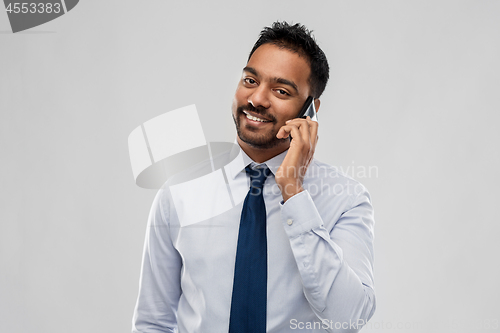 Image of indian businessman calling on smartphone