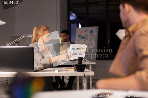 Image of designers or software developers at night office