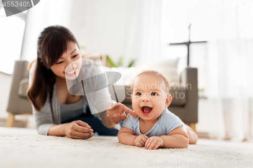 Image of happy little asian baby boy with mother at home