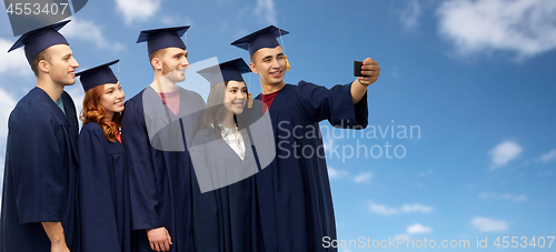 Image of graduates taking selfie by smartphone