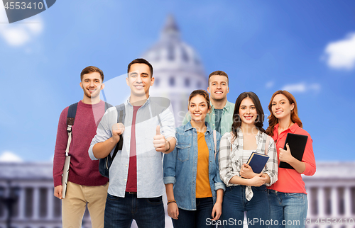 Image of students showing thumbs up over capitol building