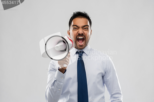 Image of indian businessman screaming over grey