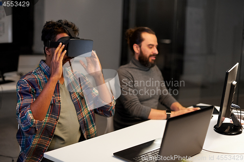 Image of creative man in virtual reality headset at office