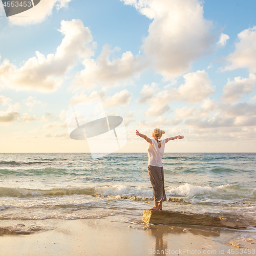 Image of Free Happy Woman Enjoying Sunset on Sandy Beach