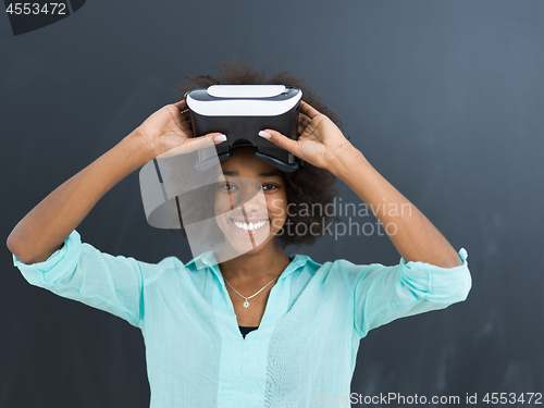 Image of black girl using VR headset isolated on gray background