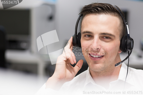 Image of male call centre operator doing his job