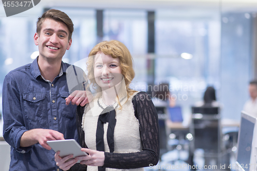 Image of Business People Working With Tablet in startup office