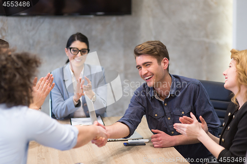 Image of cloasing the deal in modern office interior