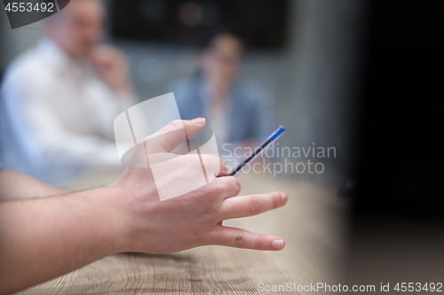 Image of businessman hand using pen