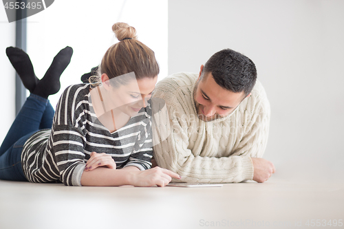 Image of Young Couple using digital tablet on cold winter day