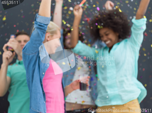 Image of confetti party multiethnic group of people isolated over gray