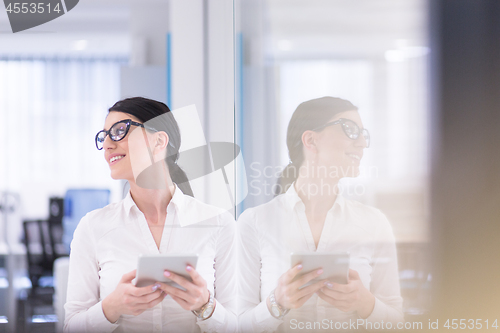 Image of Business Woman Using Digital Tablet in front of startup Office