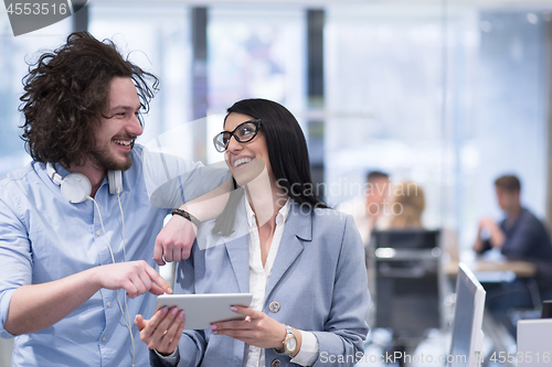 Image of Business People Working With Tablet in startup office