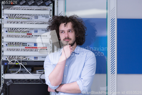 Image of business man engeneer in datacenter server room