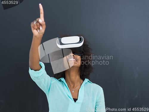 Image of black girl using VR headset isolated on gray background