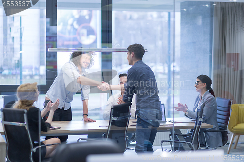 Image of cloasing the deal in modern office interior