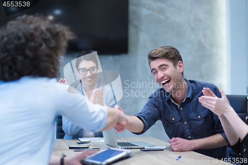 Image of cloasing the deal in modern office interior