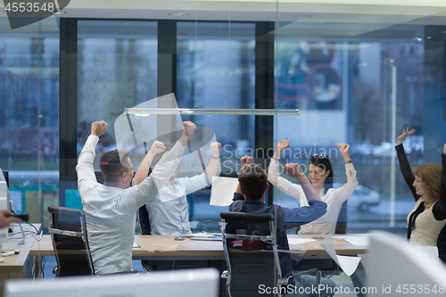 Image of startup Group of young business people throwing documents