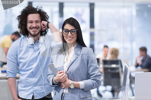 Image of Business People Working With Tablet in startup office