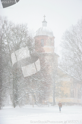 Image of Winter landscape with snow covered church and trees.