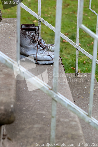 Image of Dirty old workboots on stairs.