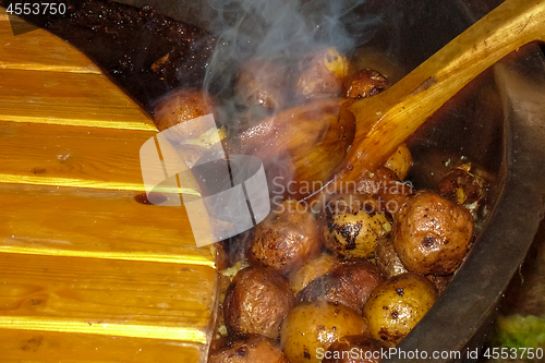 Image of Potatoes with peel in pan in outdoor. 