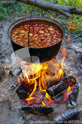 Image of Soup cooking on the fire outdoor for camping trip.
