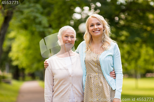 Image of daughter with senior mother hugging at park